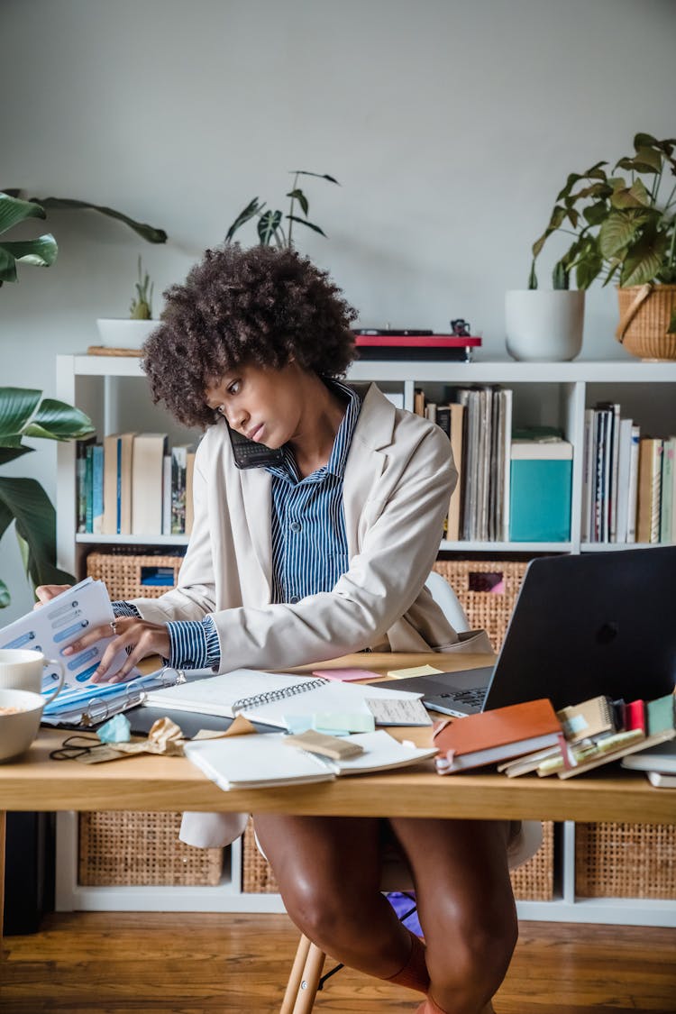 Woman Talking On Phone In Office