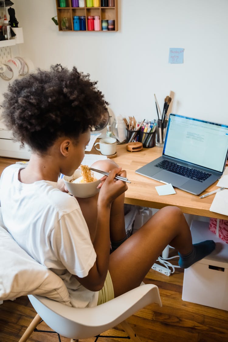 Woman Eating Breakfast At Desk