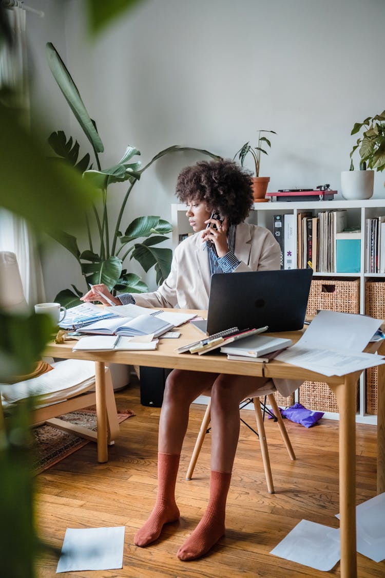 Woman Working By Desk At Home