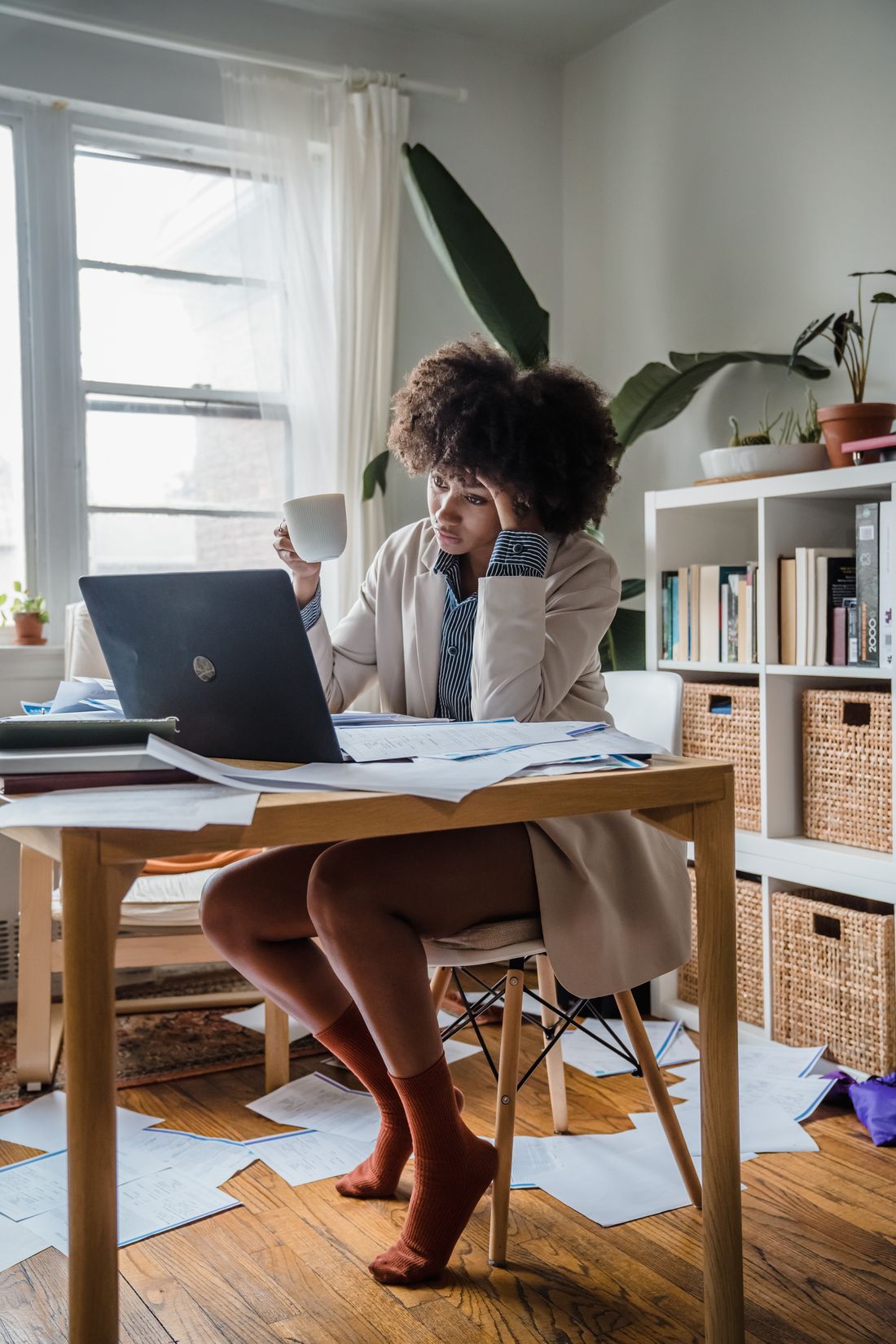 Tired professional pausing at a home office desk