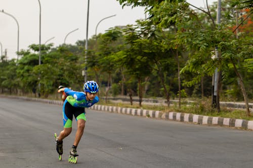 A Male Athlete Roller Skating on the Road