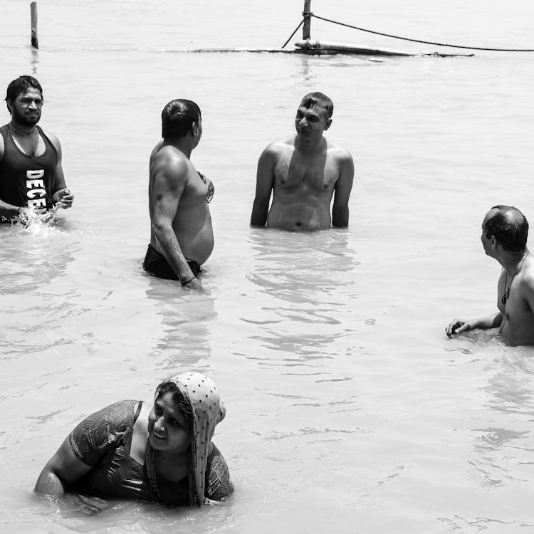 Grayscale Photo of People on Water