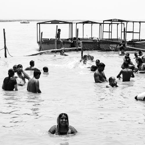 Grayscale Photo of People on Water