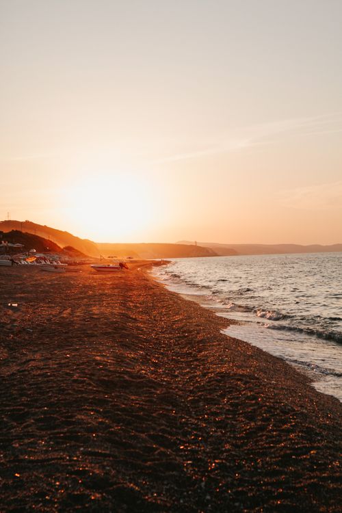 Free Experience the warm glow of a summer sunset over the serene Yalıköy Beach in İstanbul, Turkey. Stock Photo