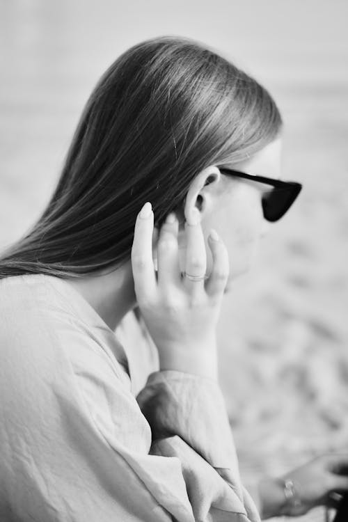 Woman in Sunglasses Touching Hair