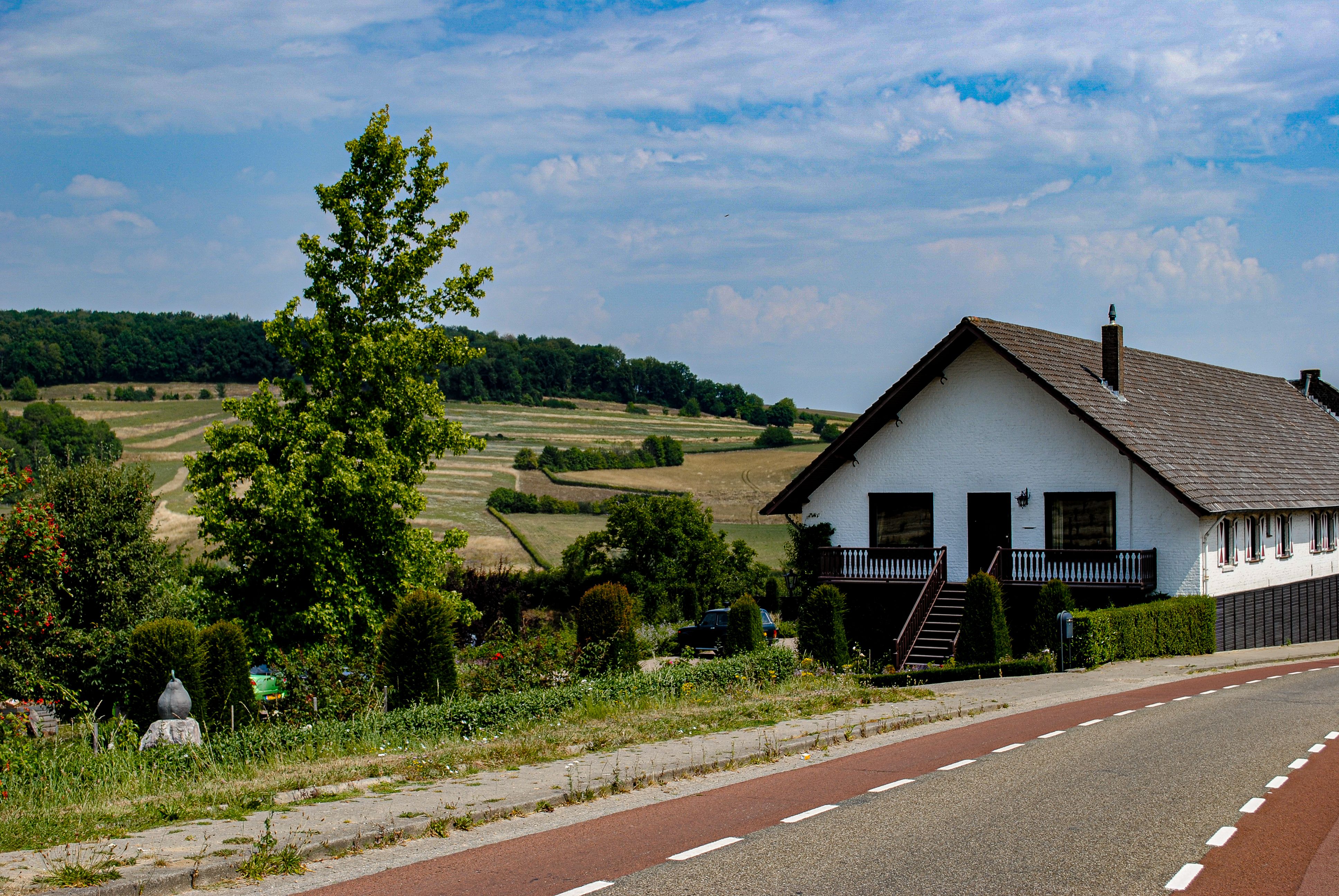 White and Brown House Near the Road Under Blue Sky · Free Stock Photo