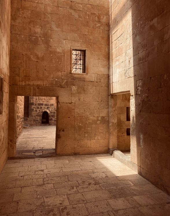 Sunlit stone corridor in a historic building