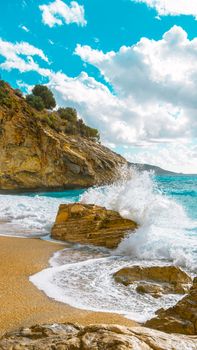 Beautiful seaside view with crashing waves and rock formations in Fethiye, Turkey.
