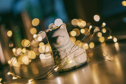 Shallow Focus Photography of White Ceramic Cat Figurine