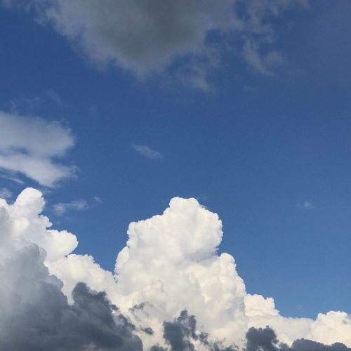 Free Vibrant cloudscape with cumulus clouds against a deep blue sky. Stock Photo
