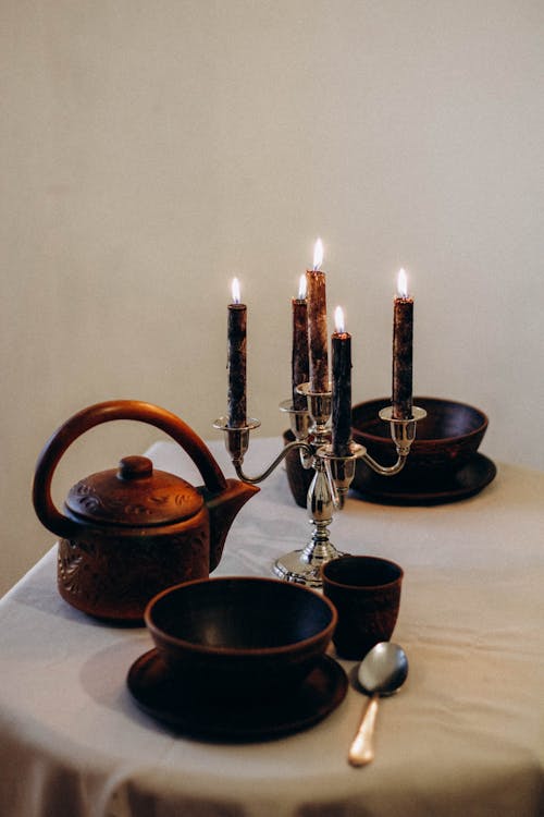 Free Clay Tableware and Candles on Table Stock Photo