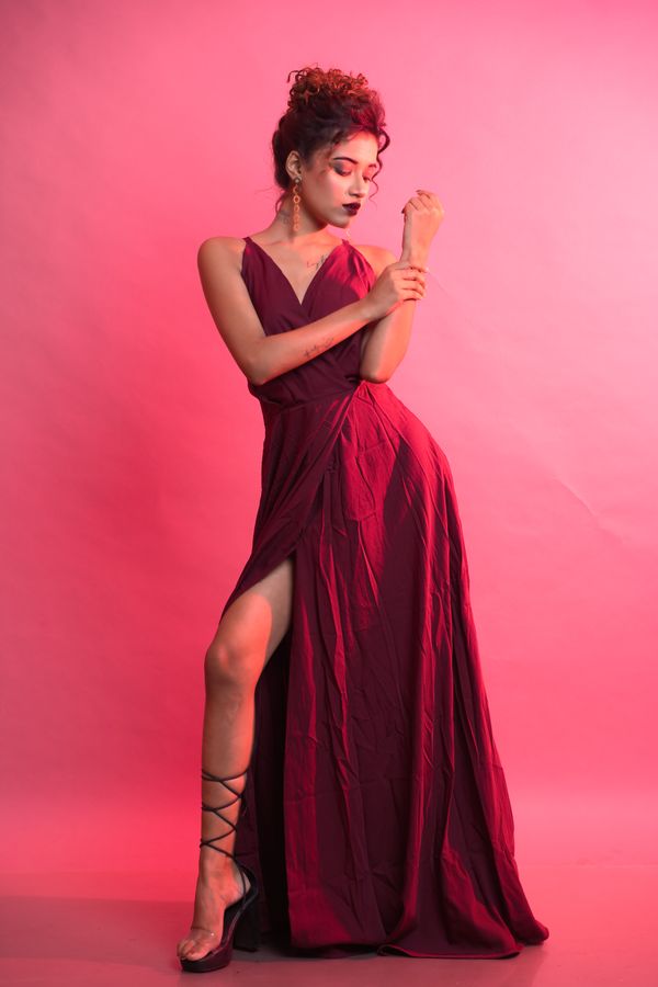 woman in deep plum satin wrap dress