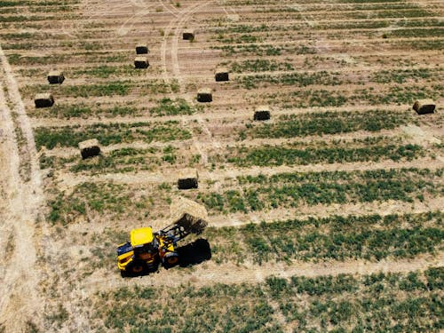 Aerial View of a Tractor on a Grassy Field
