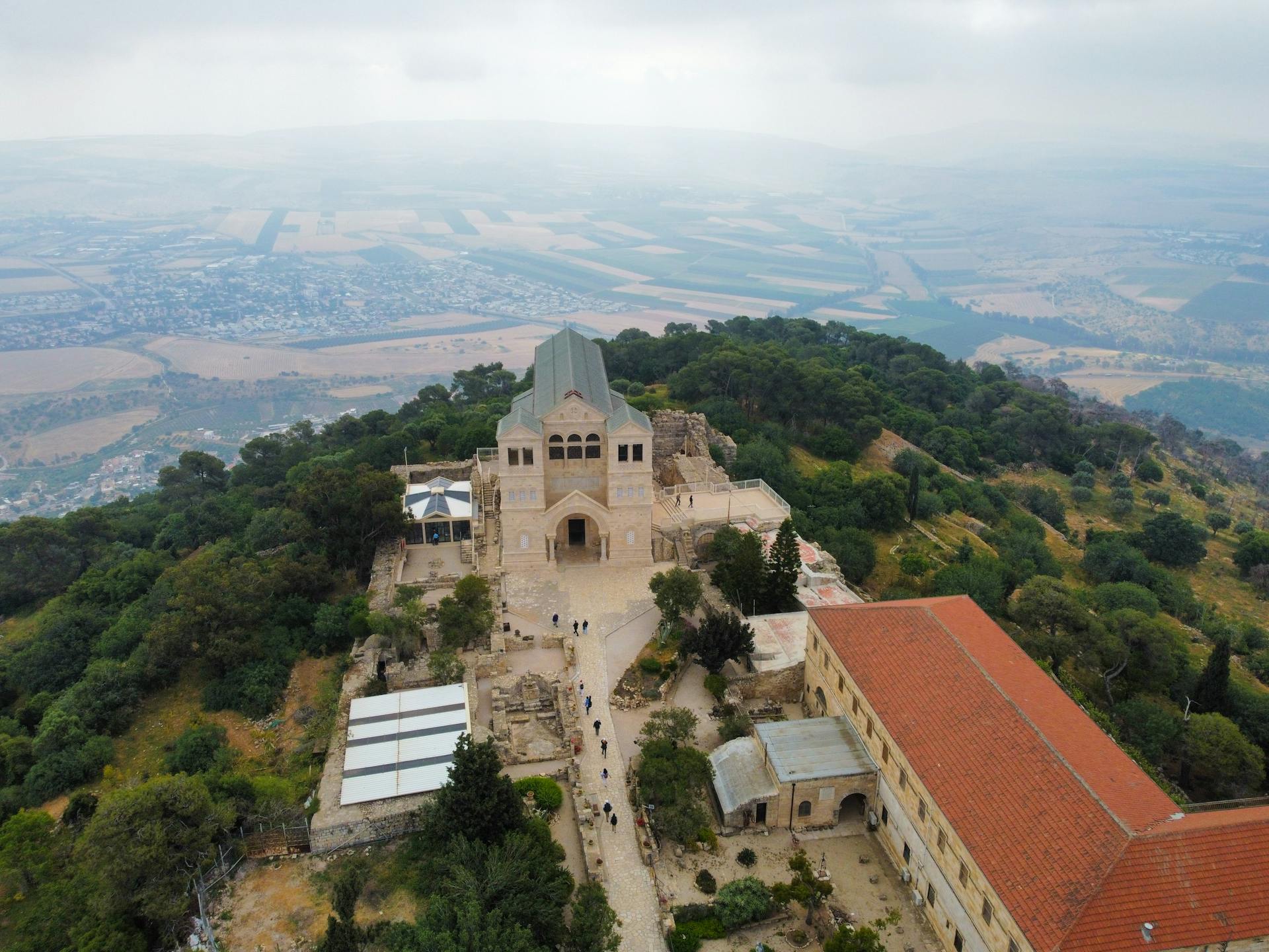 Stunning aerial photo of the Church of the Transfiguration surrounded by lush landscapes on Mount Tabor, Israel.