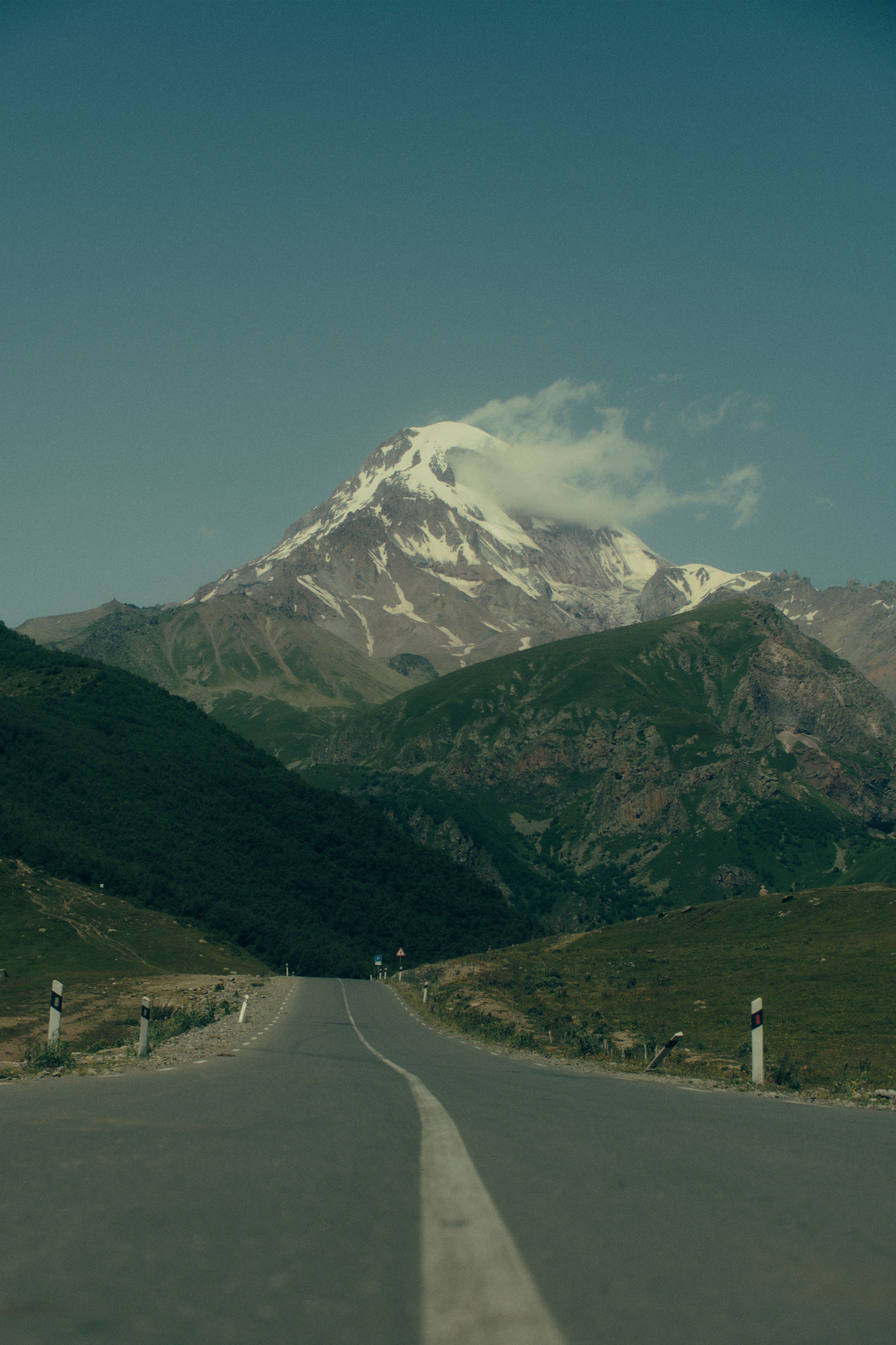 Explore the breathtaking landscape of Mount Kazbek in Georgia, captured from a scenic road.