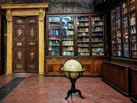 Historic library in Florence featuring wooden bookshelves, ornate doors, and a vintage globe.