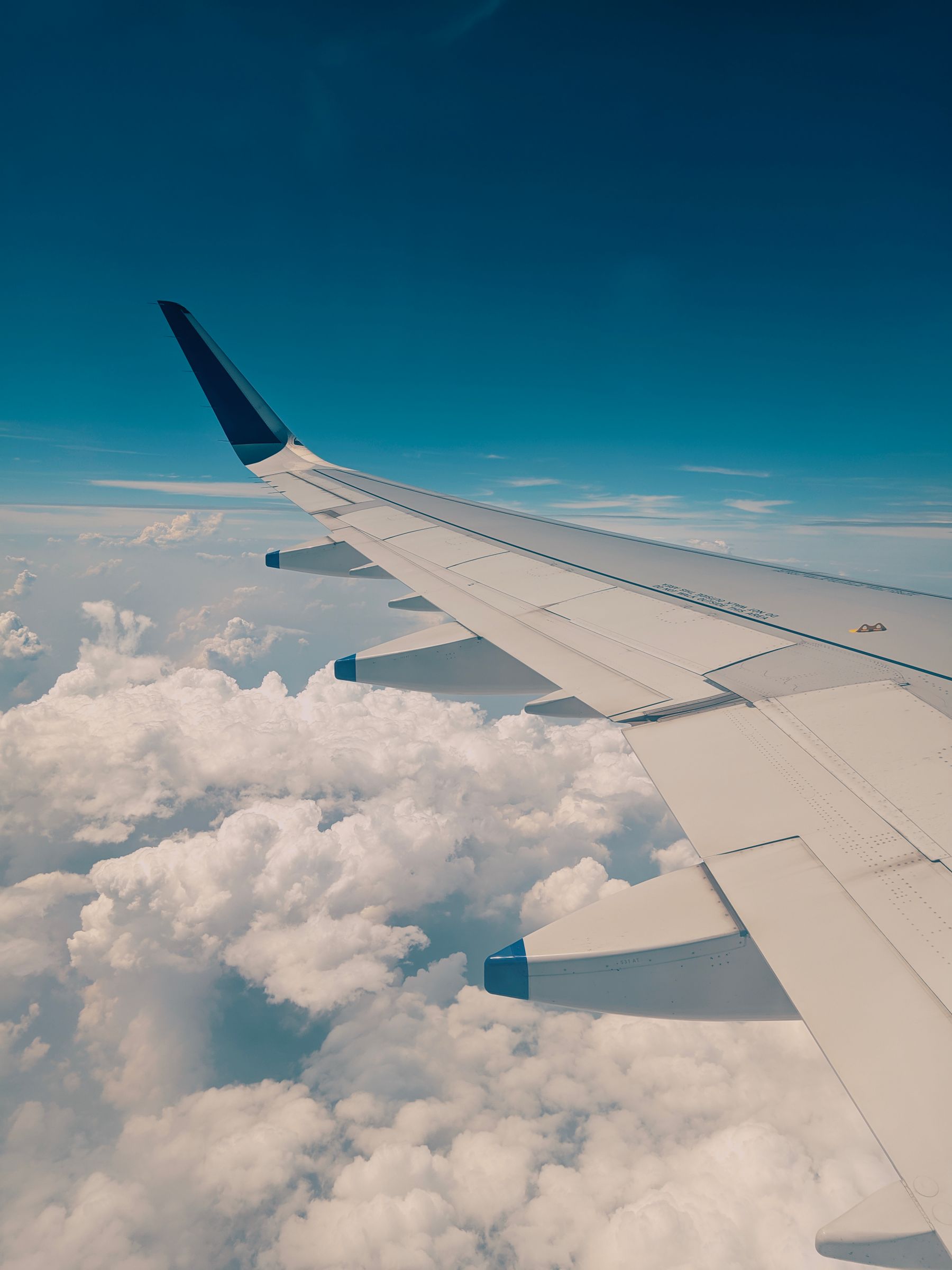 View of an airplane wing above the clouds