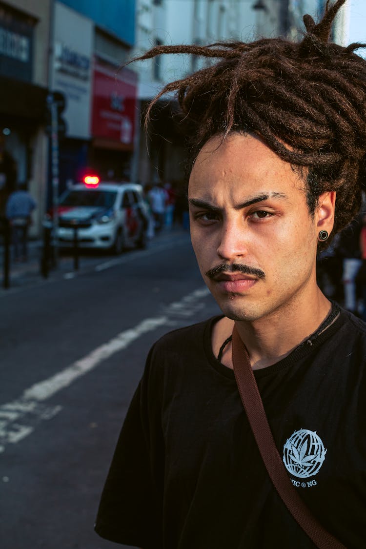 Close-Up Shot Of A Man In Black Shirt With Dreadlock Hairstyle