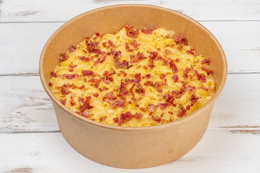 Delicious mac and cheese with crispy bacon in a bowl. Perfect comfort food.