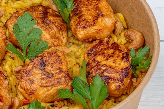 Savory grilled chicken on seasoned rice with fresh parsley garnish, a culinary delight.
