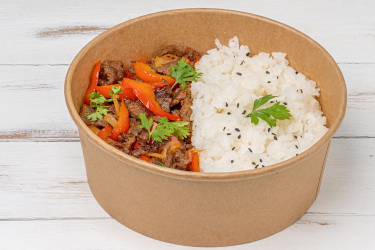 Cooked Meat With Red Pepper In Brown Paper Bowl