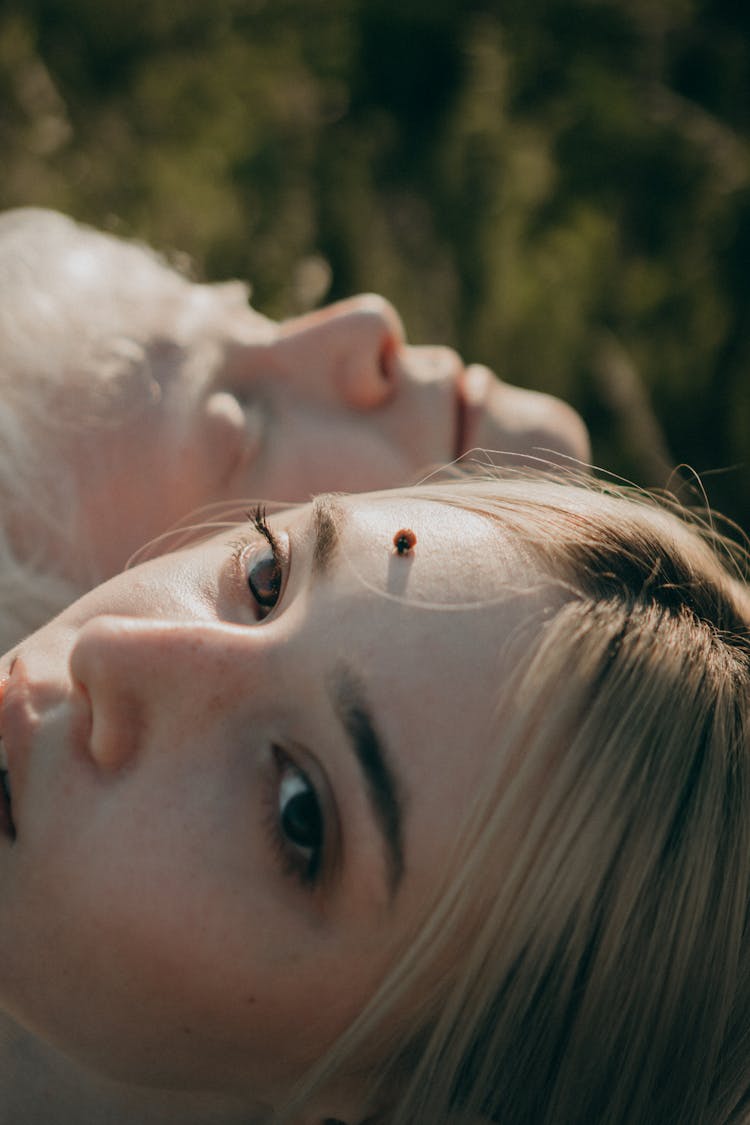 Close-up Of Couple Turning Faces To Sun Outdoors