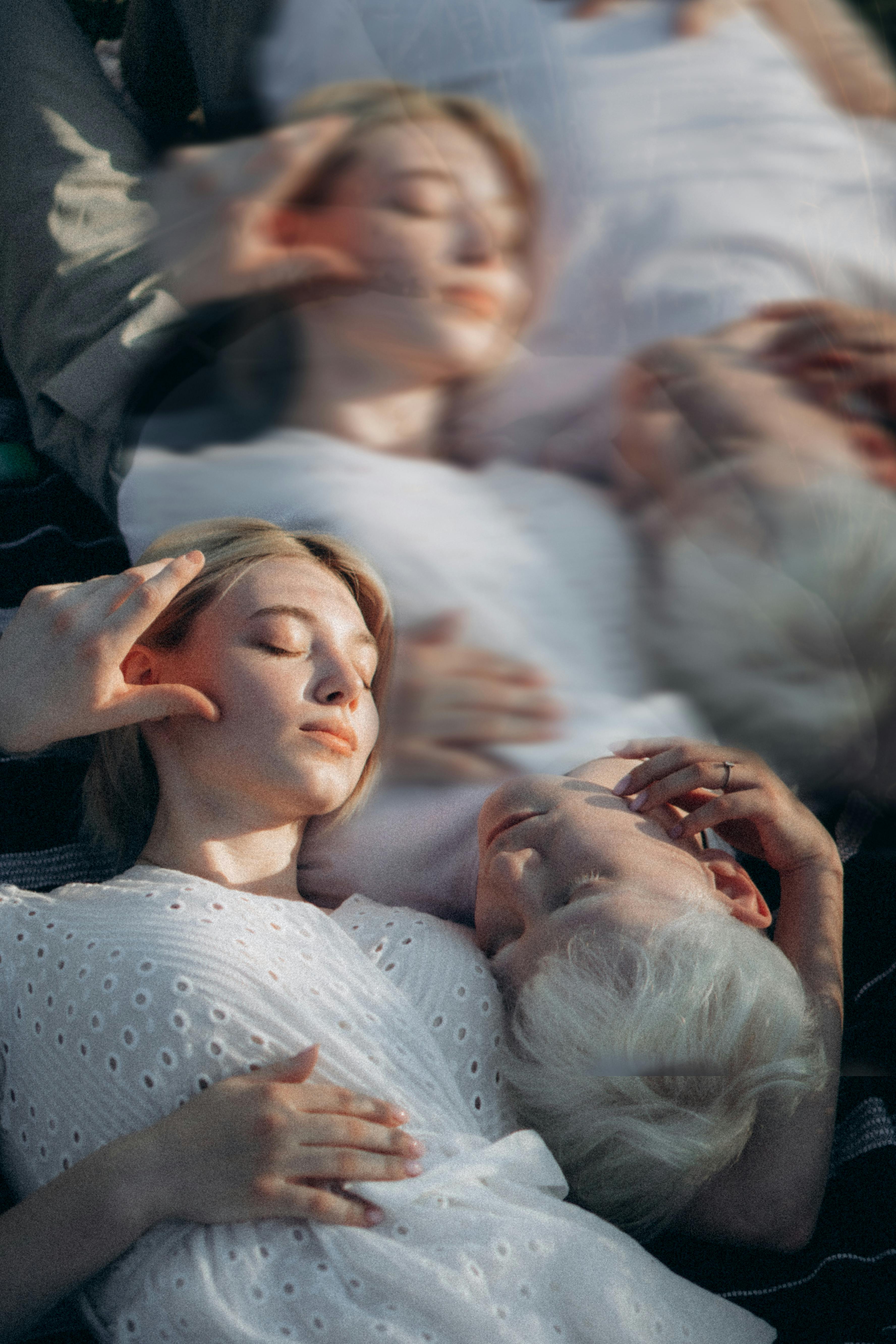 A serene artistic image of a couple embracing in a dreamy double exposure effect.