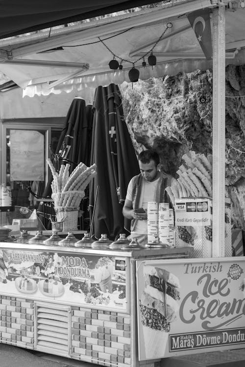 Man Standing Inside a Ice Cream Stall