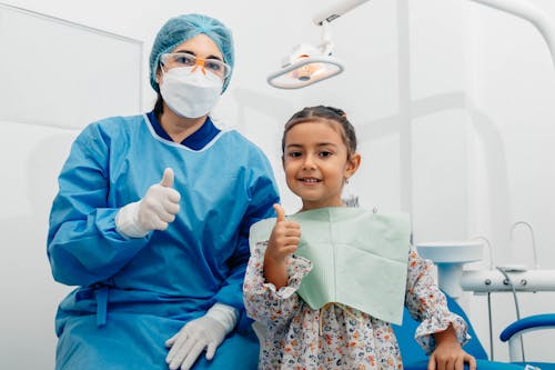 Free Dentist and Her Patient Posing at the Camera Stock Photo