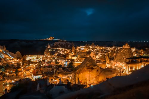 Free Discover the magical night view of Cappadocia, Turkey with its illuminated fairy chimneys and scenic landscape. Stock Photo