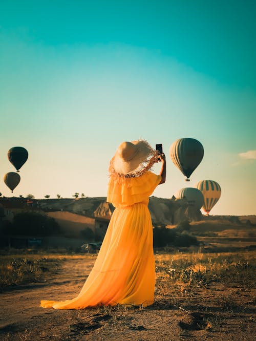 Woman in Dress in Field Watching Air Balloons