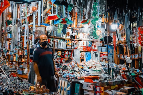 A Man in Blue Shirt Tending a Store