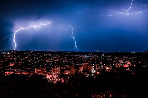 Free Dramatic night cityscape with vivid lightning illuminating the skyline. Stock Photo