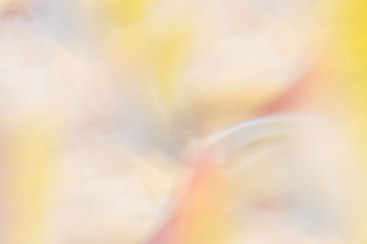 A soft, dreamy abstract composition with blurred pastel colors and light effects.