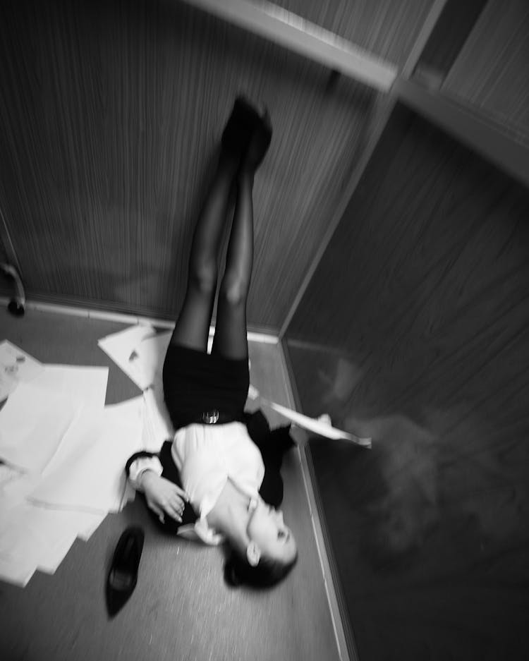 Woman Lying With Legs High Reading Documents