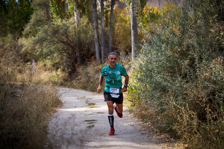 A Man Running On Dirt Road