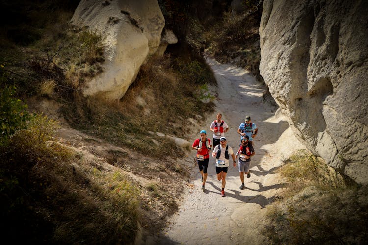 People Running On Dirt Road