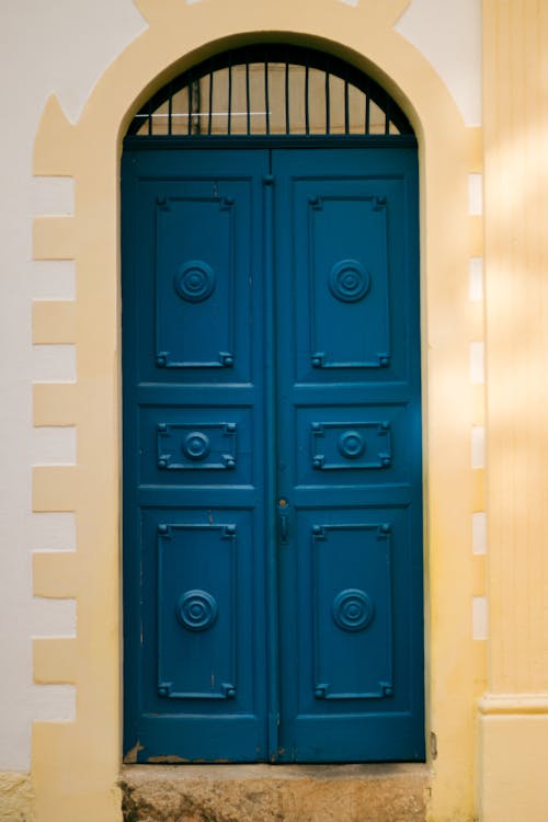 Blue Wooden Door on Yellow Wall