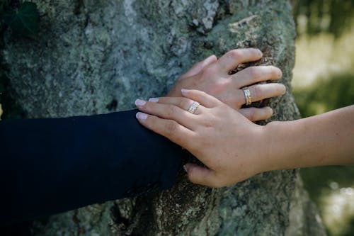 Couple Wearing Gold Wedding Rings