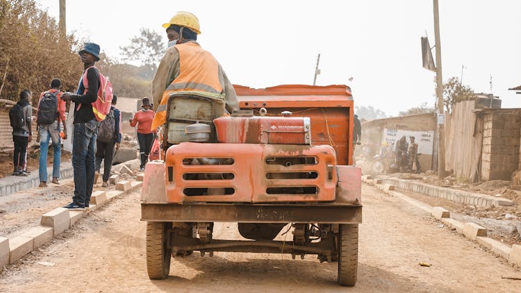 A Man Driving Orange Tractor