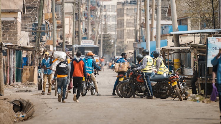 People Riding Motorcycle On The Road