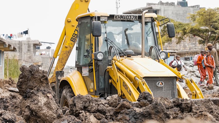 Tractor Excavating Ground At Construction Site