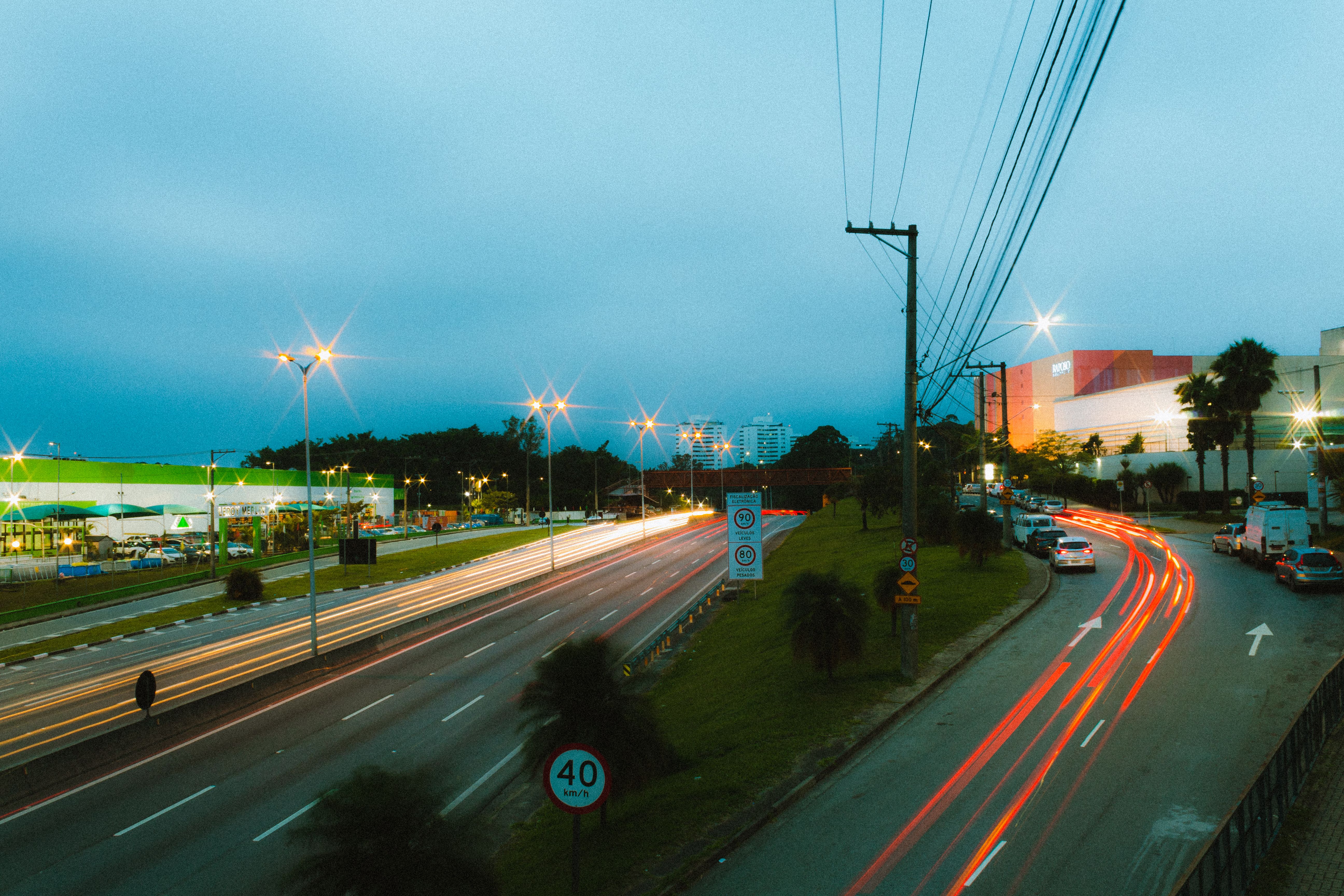 Dynamic long exposure shot of city highway at night with light trails.