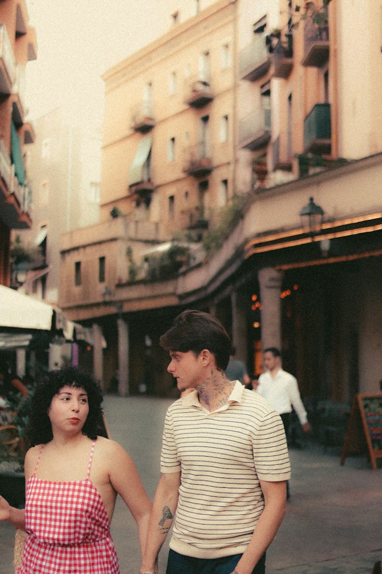 Candid Picture Of A Couple Walking In City In Summer