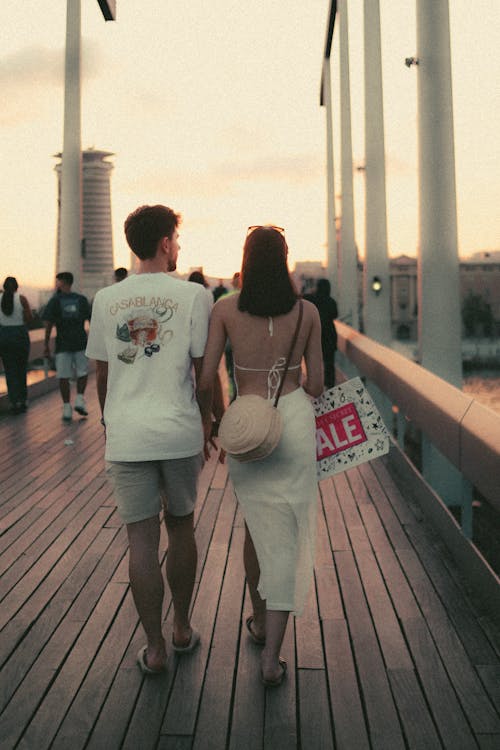 Couple Walking Together on a Footbridge