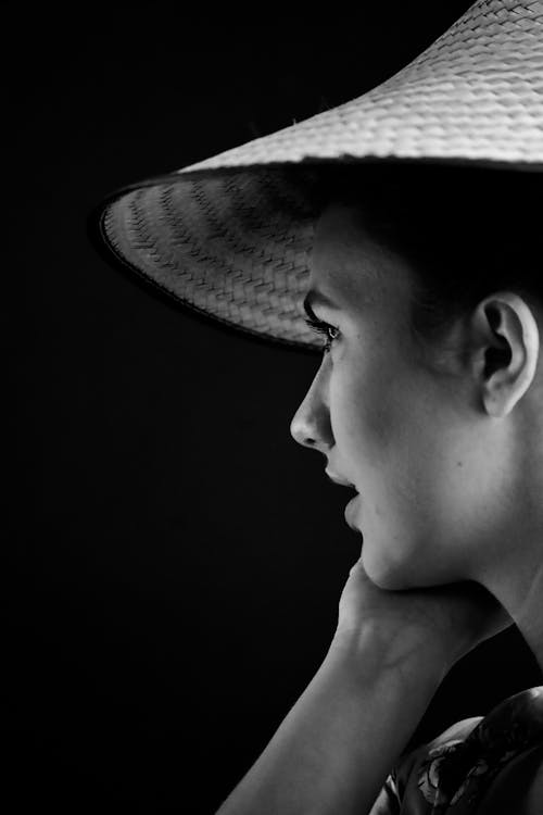 Grayscale Photo of a Woman Wearing an Asian Conical Hat