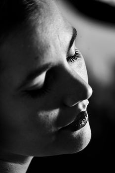 Monochrome close-up portrait of a woman's face, showcasing beauty and elegance.