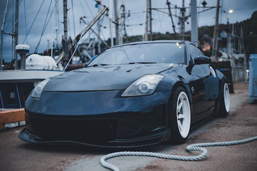 Rope Beside a Parked Black Sportscar