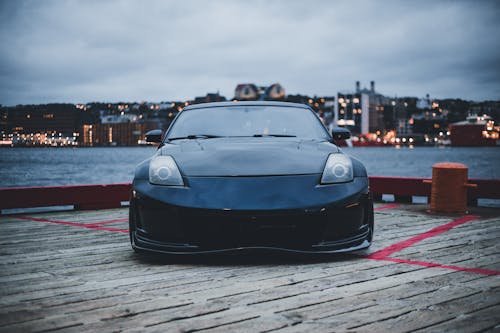Black Nissan Car Parked at a Wooden Dock