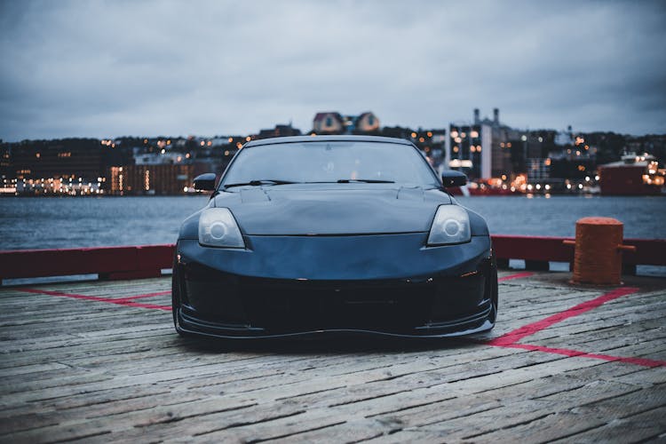 Black Nissan Car Parked At A Wooden Dock